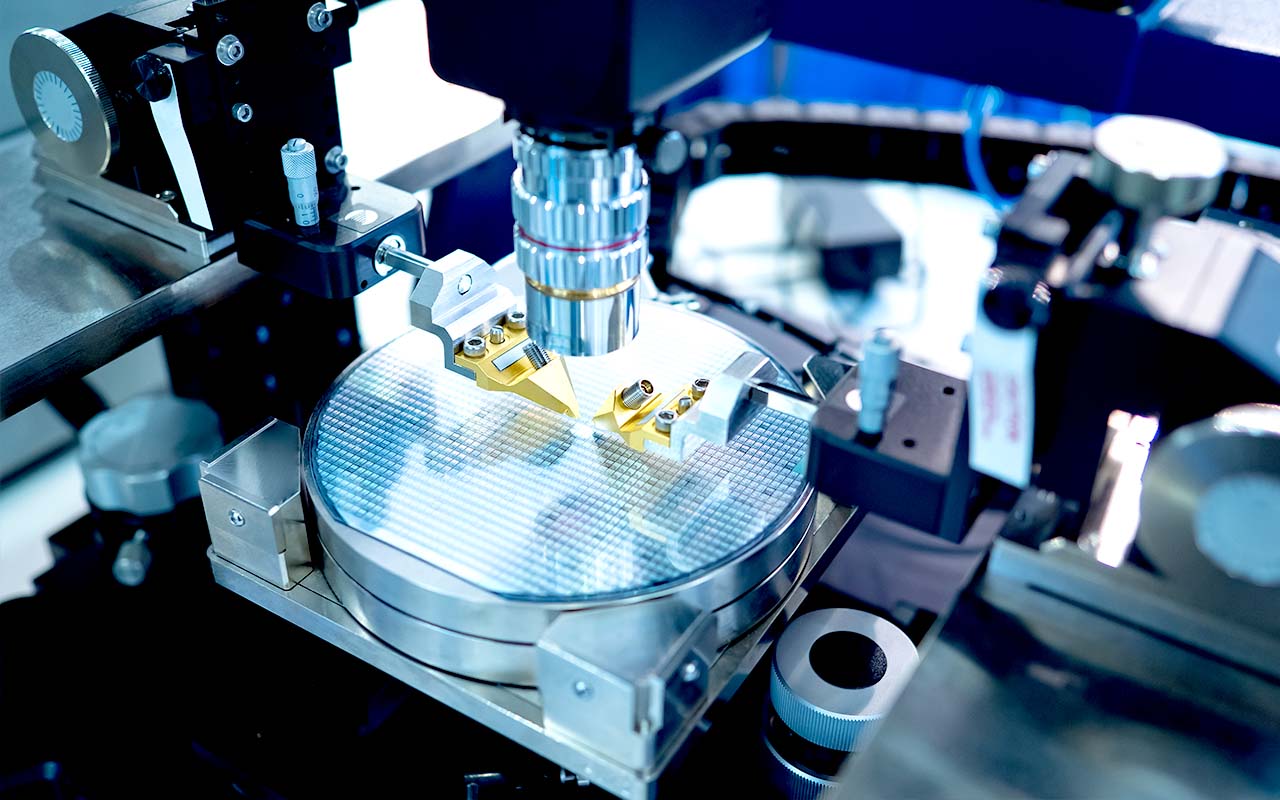 Close-up of semiconductor wafer under precision testing equipment, representing high-purity sealing solutions for various environment and wafer fabrication processes.